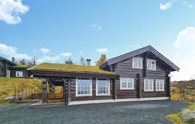 a log house with a roof at Cozy Home In Rauland With Wifi in Rauland