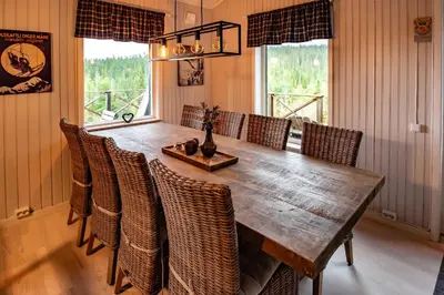 a dining room with a wooden table and chairs at Trysilfjellet Nord 267 in Trysil