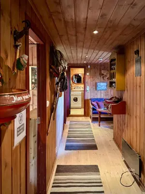 a hallway in a house with a washer and dryer at Ski in-out cabin Trysil sauna, fireplace and views in Trysil