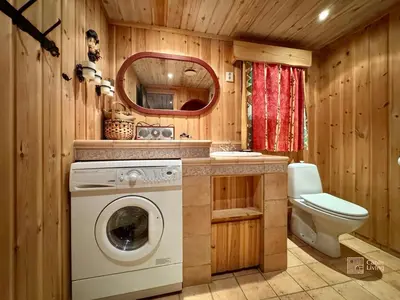 a bathroom with a washing machine and a toilet at Ski in-out cabin Trysil sauna, fireplace and views in Trysil