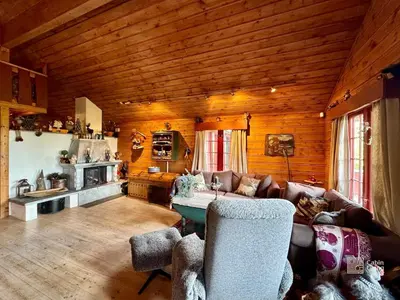 a living room with a couch and a table at Ski in-out cabin Trysil sauna, fireplace and views in Trysil