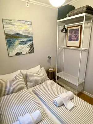 a bedroom with a bed with towels on it at Central studio apartment in Bergen