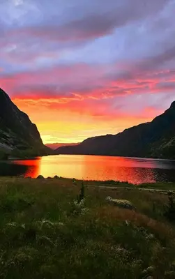 a sunset over a body of water with mountains at Renovated Cabin With Views Over Breimsvatnet in Klakegg