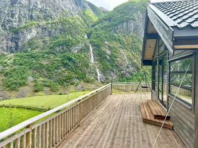 a balcony of a house with a view of a mountain at Renovated Cabin With Views Over Breimsvatnet in Klakegg
