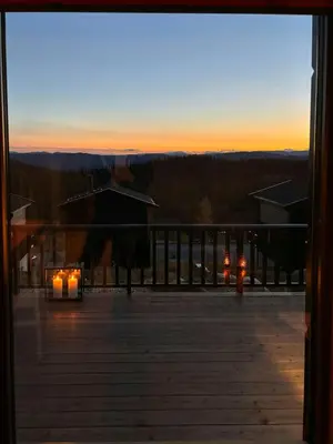 a view of the sunset from the deck of a house at Mountain Cabin With Panoramic Views In Norefjell in Noresund