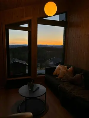 a living room with a couch and a table at Mountain Cabin With Panoramic Views In Norefjell in Noresund