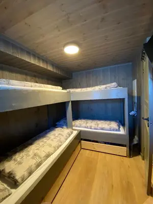 two bunk beds in a room with wooden floors at Hovden Alpin Lodge Appartement in Bykle