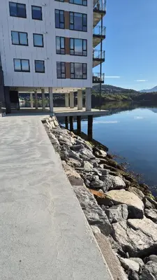 a building with a walkway next to a body of water at Apartment in Ålesund in Ålesund