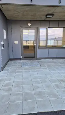 an empty room with a large glass door and windows at Apartment in Ålesund in Ålesund