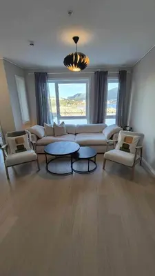 a living room with a couch and chairs and a table at Apartment in Ålesund in Ålesund