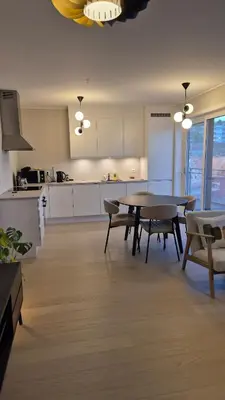 a kitchen with a table and chairs in a room at Apartment in Ålesund in Ålesund