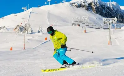 a person is skiing down a snow covered slope at New cabin in Slåseterlia at Skeikampen in Svingvoll