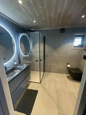 a bathroom with a shower and a sink and a toilet at New cabin in Slåseterlia at Skeikampen in Svingvoll