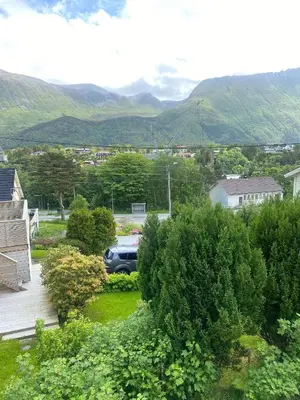 a view from the balcony of a house with mountains in the background at Mountain Retreat in Brattvg - Unwind in Nature in Brattvåg