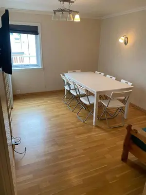 a room with a table and chairs in it at Mountain Retreat in Brattvg - Unwind in Nature in Brattvåg