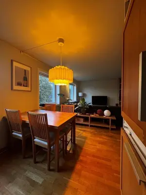 a dining room with a wooden table and chairs at Gimleveien 36G in Bergen