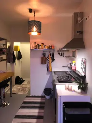 a kitchen with a stove and a counter top at Compact living with all you need, close to the centre! in Røros