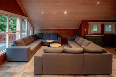 a living room with a couch and a table at Bakkebyvegen 7B in Trysil