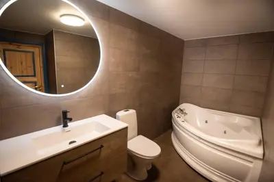 a bathroom with a sink and a toilet and a mirror at Bakkebyvegen 7A in Trysil