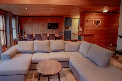 a living room with a large couch and a table at Bakkebyvegen 7A in Trysil