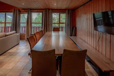 a dining room with a wooden table and chairs at Bakkebyvegen 7A in Trysil