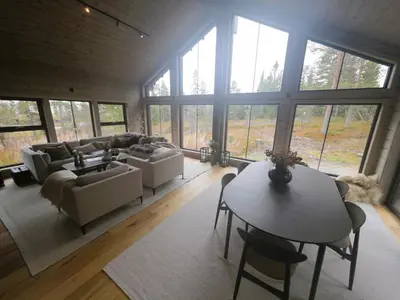 a living room with a couch and a table at Unique hytta with jacuzzi, sauna, 7 bedrooms in Trysil