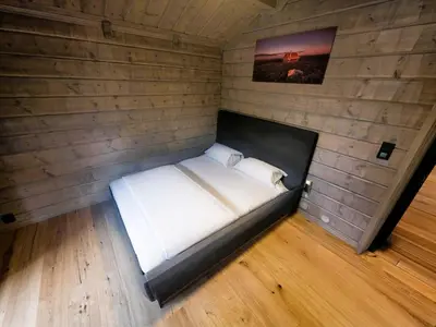 a bed in a corner of a room at Unique hytta with jacuzzi, sauna, 7 bedrooms in Trysil