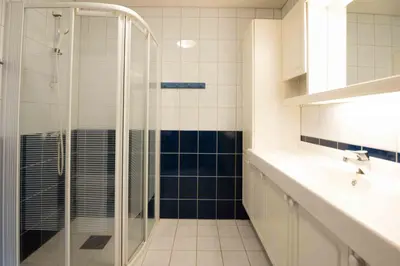 a bathroom with a glass shower and a sink at Bakkebyvegen 13A in Trysil