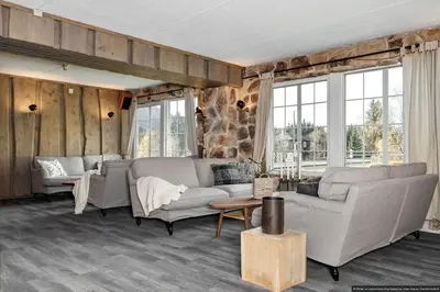 a living room with two couches and windows at Charming apartment with lodgefeeling in Hemsedal