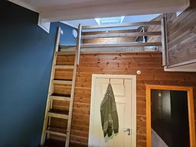 a loft bed in a tiny house at Charming apartment with lodgefeeling in Hemsedal
