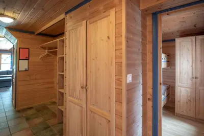 a room with wooden walls and a closet at Bakkebyvegen 13B in Trysil