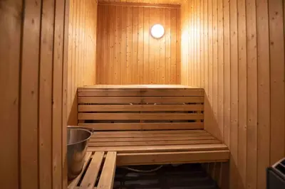 a sauna with a bench in a wooden room at Bakkebyvegen 13B in Trysil