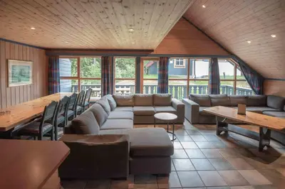 a living room with a couch and a table at Bakkebyvegen 13B in Trysil
