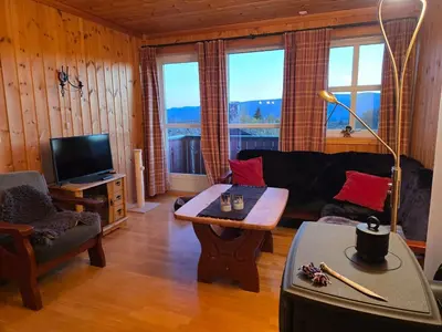 a living room with a couch and a table at Fjellstolen apartment nr 12 in Beitostøl