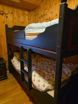 two bunk beds in a room with wooden walls at Fjellstolen apartment nr 12 in Beitostøl