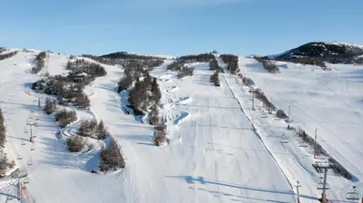 a ski slope with snow and trees on it at Timber Cabin With Mountain View in Beitostøl