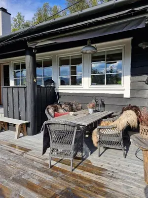 a patio with a table and chairs on a house at Cozy Family Cabin At Hamlagrø in Vossevangen