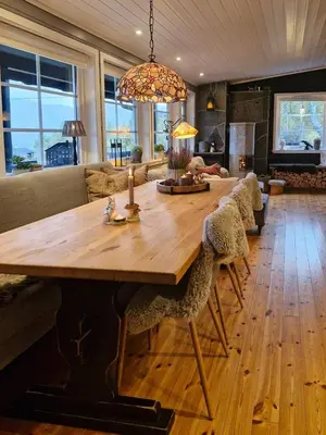 a living room with a large wooden table and chairs at Cozy Family Cabin At Hamlagrø in Vossevangen