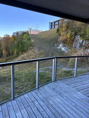 a wooden deck with a view of a hill at Large Ski in-Ski out Apartment for Groups in Hemsedal