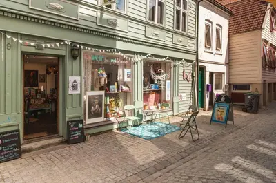 a store on a street in a city with a store front at King Bed Renovated and Cozy Near Bryggen in Bergen