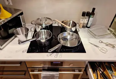 a kitchen counter with pots and pans on a stove at King Bed Renovated and Cozy Near Bryggen in Bergen