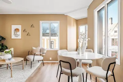 a dining room with a white table and chairs at Barfot Apartment - Bergen City center in Bergen