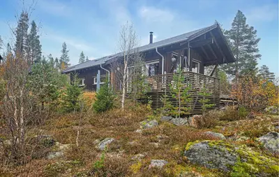 a house on top of a hill in the woods at Nice Home In Tinn Austbygd With Sauna in Luråsgrendi