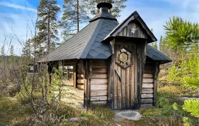 a small log cabin with a black roof at Nice Home In Tinn Austbygd With Sauna in Luråsgrendi