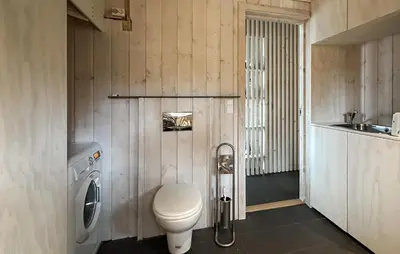 a bathroom with a toilet and a sink at Nice Home In Tinn Austbygd With Sauna in Luråsgrendi