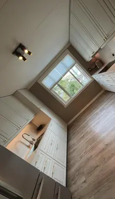 an overhead view of a kitchen with a window at Toppleilighet i sentrum av øystese in Kvam