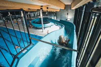 a woman is in a swimming pool in a building at Toppleilighet i sentrum av øystese in Kvam