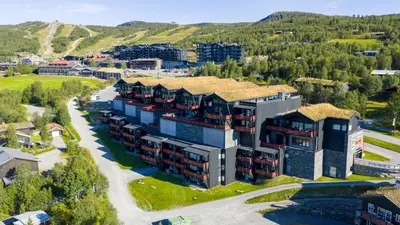 an aerial view of a resort with mountains in the background at Leilighet For 4 I Sentrum in Beitostøl