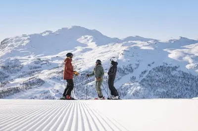three people standing on top of a snow covered mountain at Ski in-Ski out and True Mountain Charm in Hemsedal