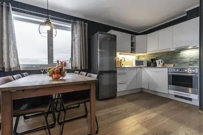 a kitchen with a table with a bowl of fruit on it at Family-Friendly Ski in-Ski out Retreat by Skarsnuten in Hemsedal